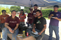 group under tent at barbeque