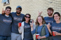 small group smiling and giving hook 'em horns hands