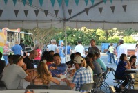 group of people under tent eating at tables