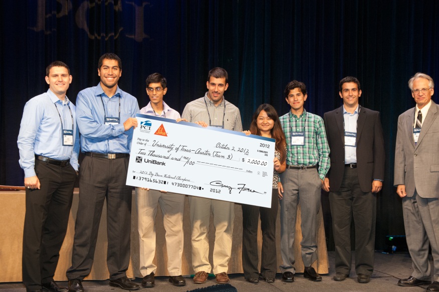 group on stage holding oversized check