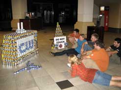kids looking at project made of cans
