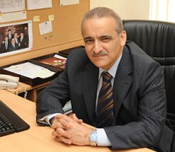 Bilal Hamad sitting at desk smiling